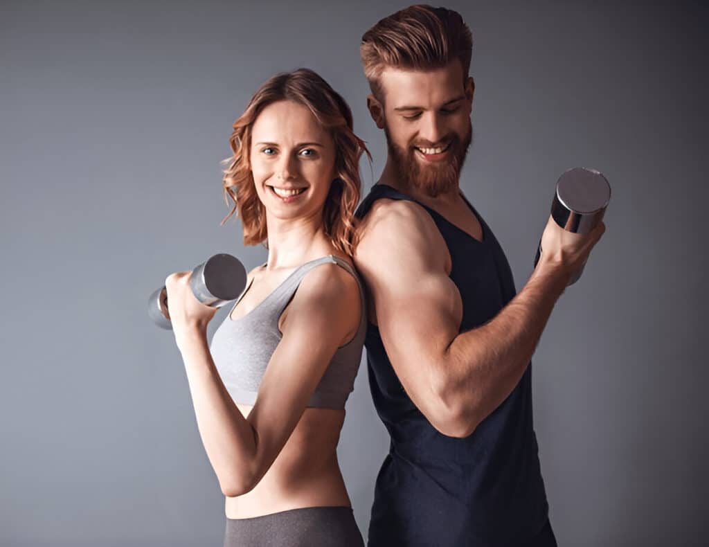 About Me 3 Ivy and her husband Marcus smiling while lifting dumbbells, representing their active lifestyle and love for fitness and healthy eating