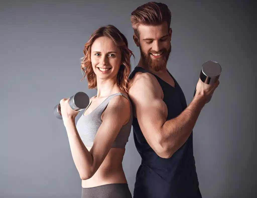 About Me 3 Ivy and her husband Marcus smiling while lifting dumbbells, representing their active lifestyle and love for fitness and healthy eating